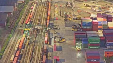 Drone forward descent above Trafford Park intermodal rail container terminal at Stock Footage 340344272