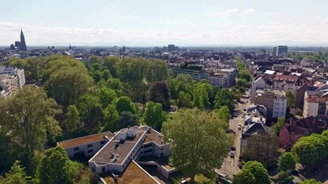 Drone forward flight above Parc du Contades and Strasbourg Cathedral skyline 動画素材 339057802