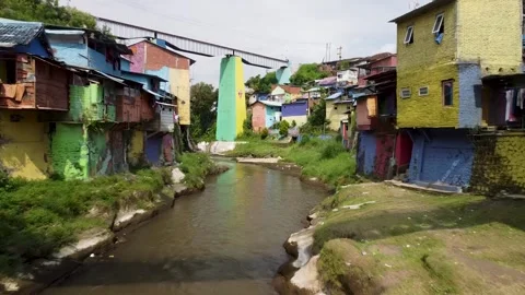 Drone Forward Flight Along River in Colorful Village, Malang, Indonesia Stock Footage 315190984