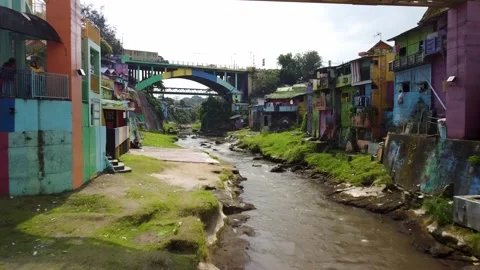 Drone Forward Flight Along River with Riverside Houses, Malang, Indonesia Stock Footage 315190987