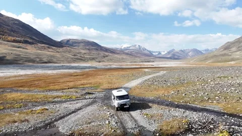 Drone forward flight along unpaved track beside White Milky River 스톡 동영상 348400899