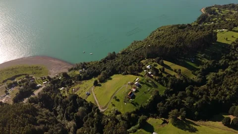 Drone Forward Flight with Camera Tilt Down Over Hill Houses and Fjord Stock-Footage 334659170