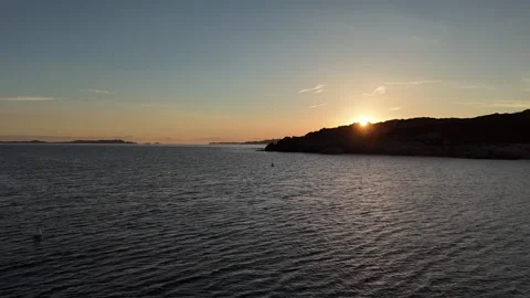 Drone Forward Flight During Sunrise Over Crystal Clear Beach in Golden H Stock Footage 332419185