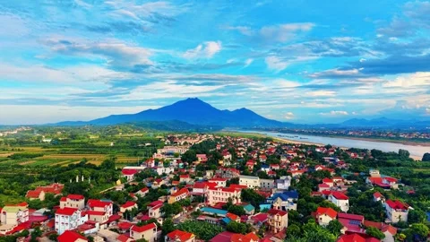 Drone forward flight over red roof village near river toward Ba Vi mountain 4K Vídeo Stock 340747580