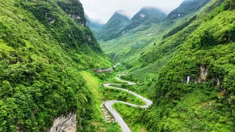 Drone forward flight through mountain gap revealing Tham Ma Pass 4K Stock Footage 341543114