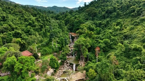 Drone forward flight toward natural hot spring waterfall in Ba Vi forest 4K Stock Footage 341551205