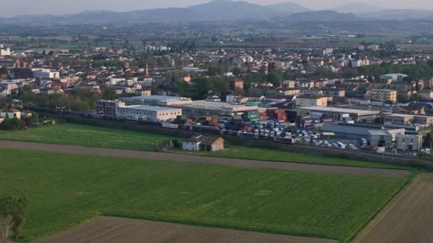 Drone forward flyover revealing freight train crossing Fiorenzuola d'Arda and Stock Footage 340604341