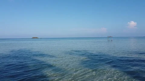 Drone Forward Motion Over Shallow Sea Toward Toward Small Tropical Island Stock Footage 330045696