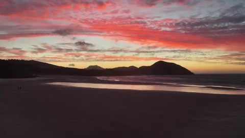 Drone forward motion over South Island New Zealand beach at dramatic sunset Stock Footage 336356729