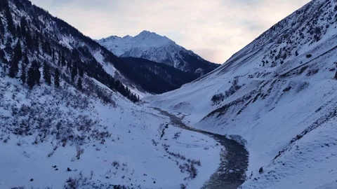 Drone forward move over river in snowy mountains Stock Footage 327690995