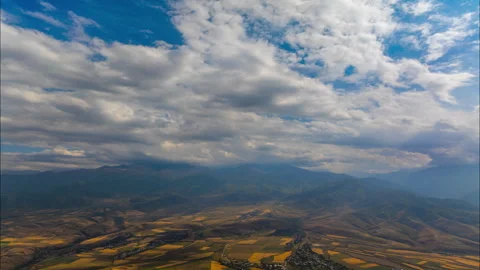 Drone forward moving hyperalpse of clouds flow above mountains in Kyrgyzstan 動画素材 335688182