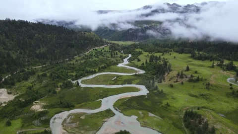 Drone Forward Over Winding Stream and Plateau Grassland Sichuan China Stock Footage 330457395