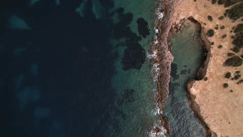 Drone forward top down view of the rocky and dry coastline of Ibiza in summer Vidéo 175651141