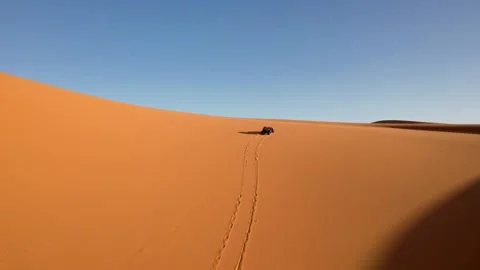 Drone forward tracking side-by-side UTV crossing Erg Chebbi sand dunes near Stock Footage 339639917