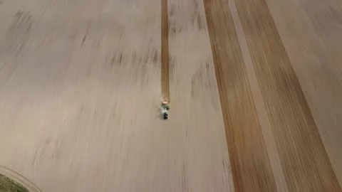 Drone front view planting wheat in the field on Valtra tractor Stock Footage 234716792