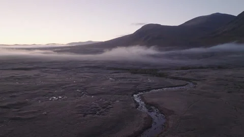 Drone of Glencoe, Scotland with low clouds at sunrise Stock Footage 254708693