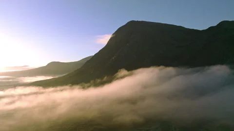 Drone of Glencoe, Scotland with low clouds at sunrise Stock Footage 254710568