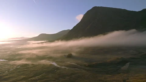 Drone of Glencoe, Scotland with low clouds at sunrise Stock Footage 254711876