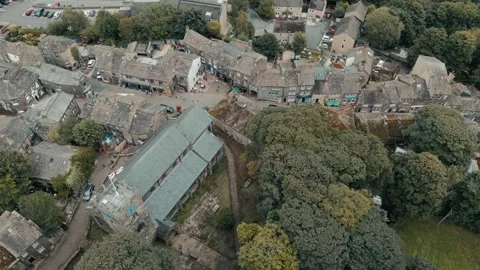 Drone glides above ancient stone cottages Vídeos de archivo 346858801