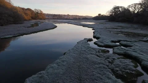 A Drone Glides Low Over An Estuary In Winter With Frost At Sunrise Stock Footage 301091932