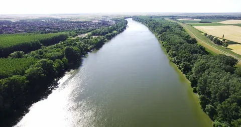 Drone glides over river Tisza in Serbia and captures its green surroundings Stock Footage 266158237