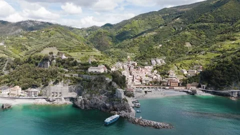 Drone glides parallel to the Cinque Terre coast, capturing cliffs, trails, and Stock-Footage 319525581