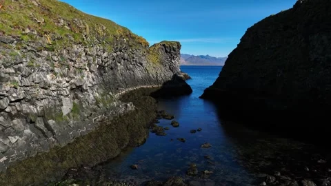 Drone glides through a narrow volcanic inlet near Arnarstapi, Iceland Stock Footage 347845091
