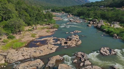Drone gliding just above Crocodile River surface reflecting midday African light Stock Footage 340263705