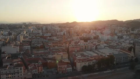 Drone gliding over Malaga city rooftops at golden hour sunset, revealing de.. Stock Footage 341828605
