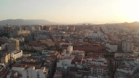 Drone gliding over Malaga cityscape at sunset, revealing dense urban sprawl.. Stock Footage 341828611