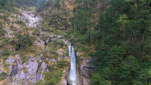 Drone gliding over misty spray from a spectacular North Sikkim waterfall. Stock Footage 311389164