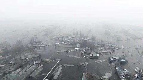 Drone gliding over the peaceful union of fog and ice over a village inside the Stock Footage 311020706