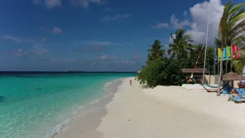 Drone gliding over pristine white sand beach of a maldives 4 star luxury resort. Stock-Footage 152576669