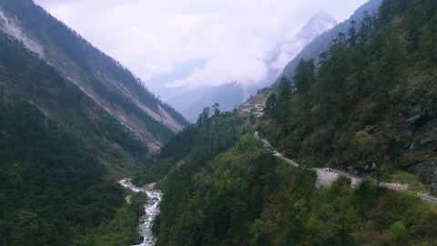 Drone gliding over winding roads cutting through the green valley in Sikkim. Stock Footage 311389158