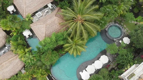 Drone going up. Aerial view of azure water in pools in luxury hotel with straw Stock Footage 128238945
