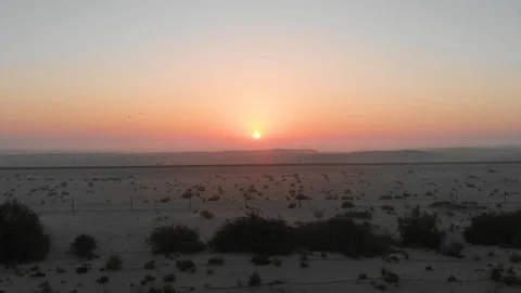 Drone is Going into the Desert Over the Defence at Sunset Stock Footage 130070248
