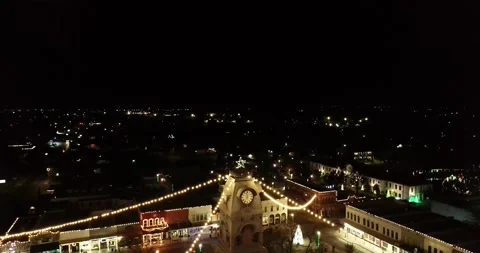 Drone going down and Texas Courthouse with Christmas Lights Stock Footage 167771423