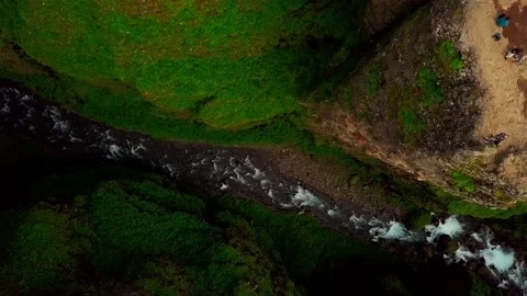 Drone going down the secret Glymur river between mountains in Iceland, 2K Stock Footage 148748238