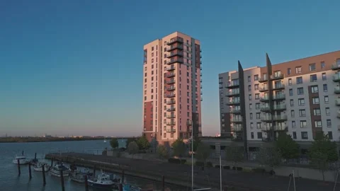 Drone golden hour push-In towards waterfront apartment tower [4K] Stock Footage 335879055