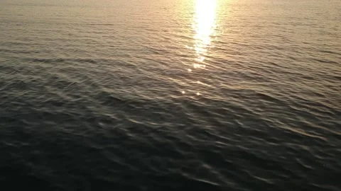 Drone, golden ocean reflections, slow fly over the water Stock Footage 131434775