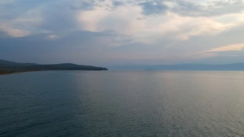 The drone gradually flies down the surface of the water. Lake Baikal, nature of Stock Footage 123914820