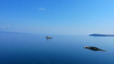 The drone gradually flies over the surface of the water. Lake Baikal, Russia Stock Footage 124230837