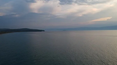 The drone gradually flies over the surface of the water. Lake Baikal, nature of Stock Footage 127951512
