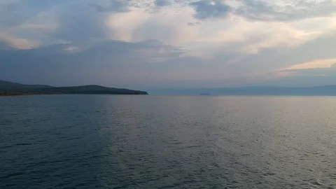 The drone gradually flies over the surface of the water. Lake Baikal, nature of Stock Footage 128319924
