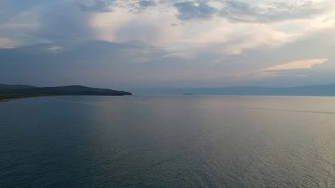 The drone gradually flies over the surface of the water. Lake Baikal, nature of Stock Footage 128319961