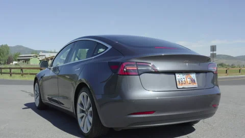Drone of a gray Telsa Model 3 driving on a country road in Park City, Utah. Stock Footage 144472268