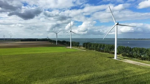 Drone green fields wind turbines blue sky static Vidéo 343244753