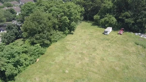Drone green trees clouds reveal development left Stock Footage 91866716