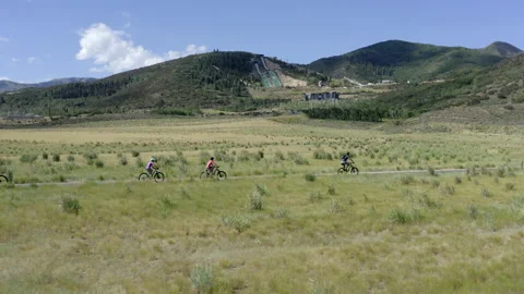 Drone of group biking on a paved trail near Utah Olympic Park, Park City. Video stock 144462022
