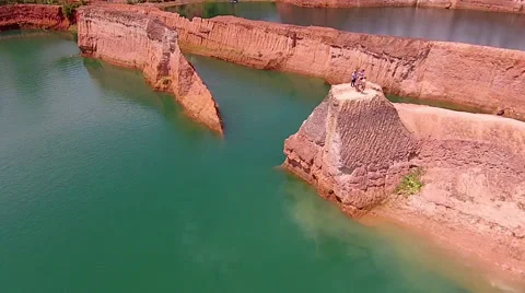 Drone: Guy Convincing His Buddy to Jump Off Cliff Into Water Stock Footage 55296919